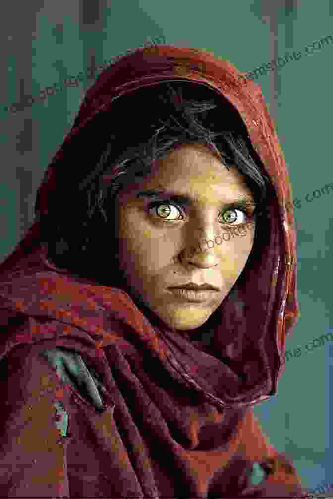 A Young Afghan Girl With Piercing Green Eyes Looks Out From A Refugee Camp In Pakistan. National Geographic Simply Beautiful Photographs